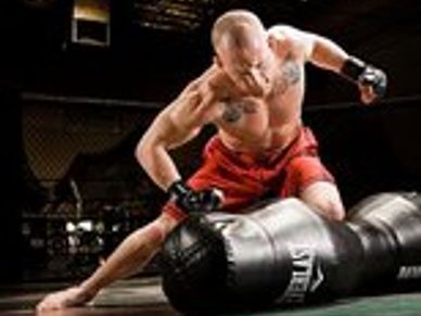 Mixed Martial Arts fighter working out on a bag