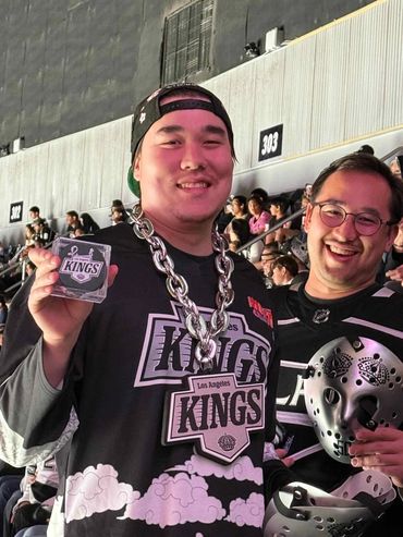 Two excited fans at a Kings hockey game.