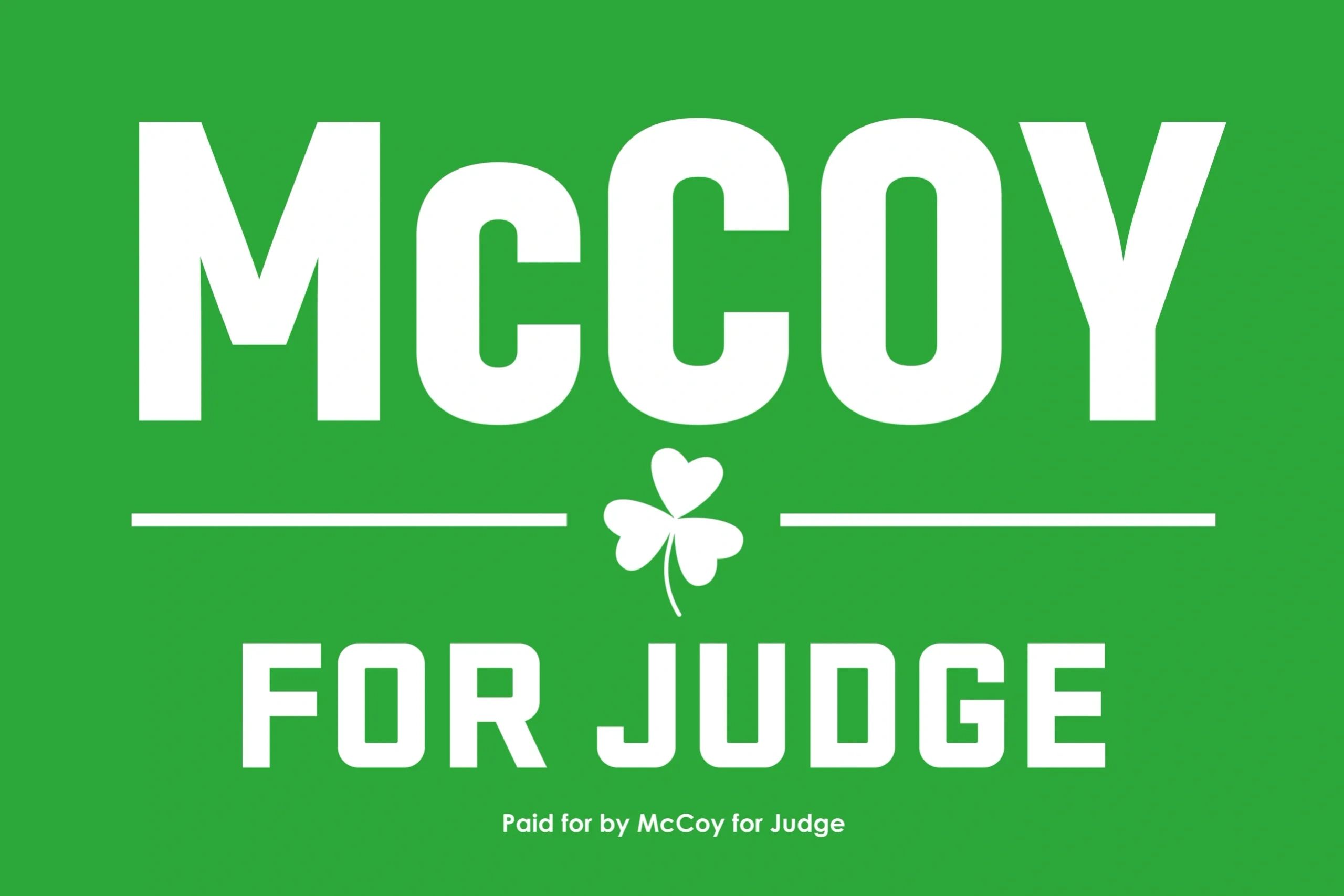 Green political sign for McCoy judge campaign.