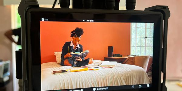 A video shoot with woman reading books on the bed