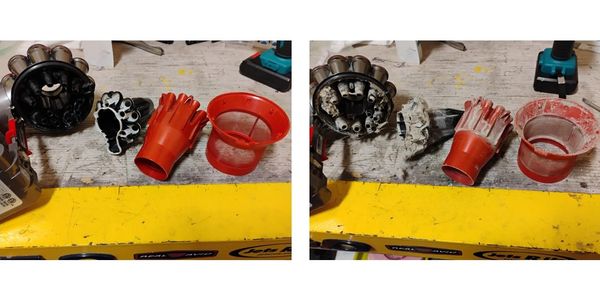 Two sets of disassembled red and black mechanical parts on a workbench.