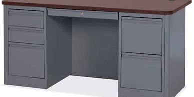 A gray metal office desk with a brown wooden top and multiple drawers.
