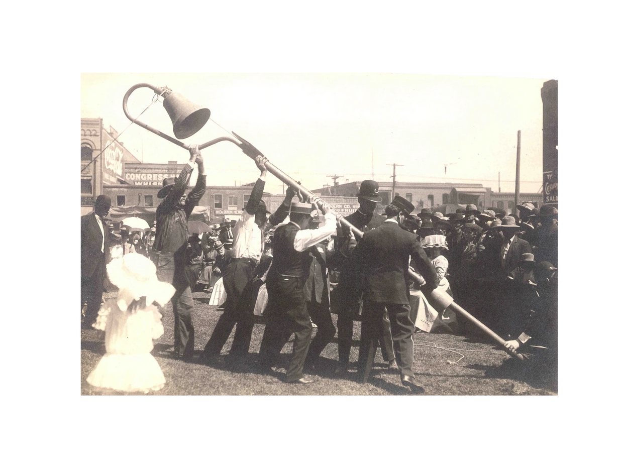 Black and white image of people straightening a lamp