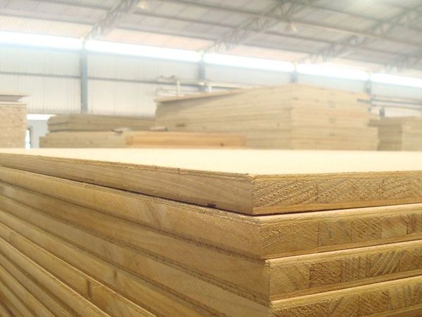Stacks of plywood sheets in a warehouse.