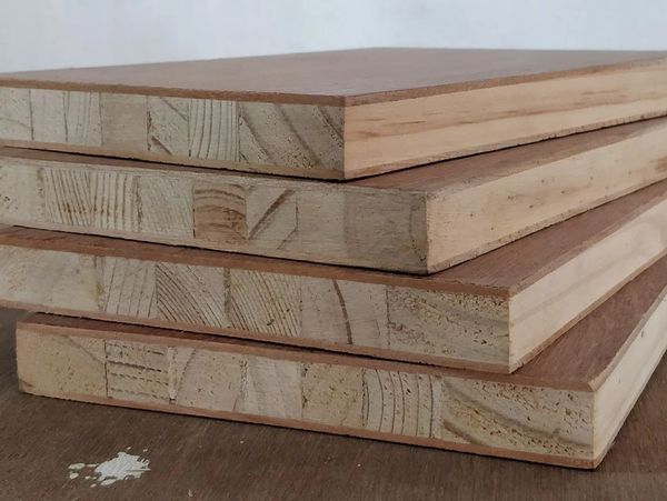 Stack of wooden plywood boards with visible layers and grain patterns.