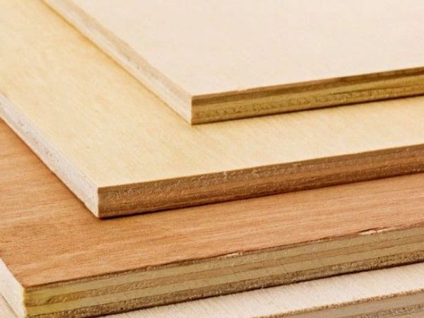 Stack of plywood sheets in varying shades and thicknesses.