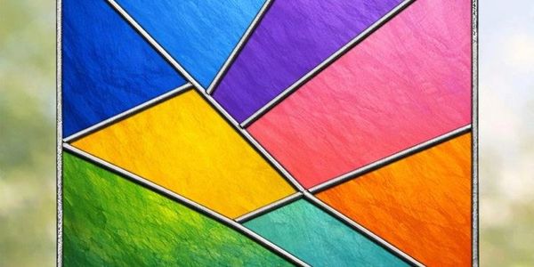 Colorful stained glass window with geometric shapes.