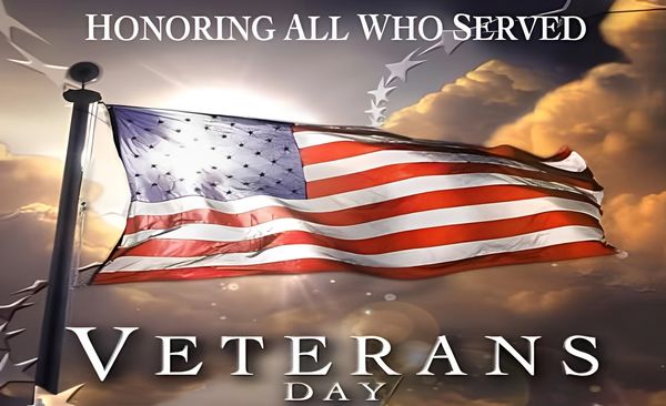 American flag waving at sunset with text Honoring All Who Served - Veterans Day tribute