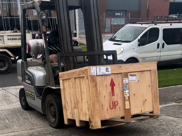 Pisca Prints first machine getting delivered and moved with a forklift.