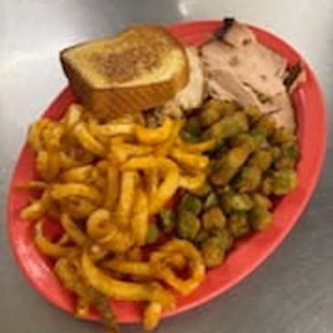 Plate with curly fries, fried okra, sliced turkey, and toast.
