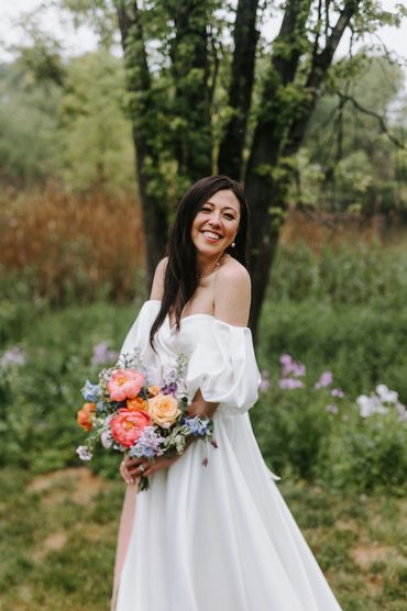 Bride holding a colorful spring bouquet at City Winery Hudson valley wedding