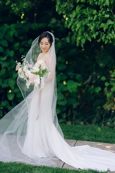 Bride holding a cascade bouquet at spring wedding at the Roundhouse, Beacon