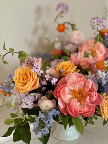 pastel spring centerpiece with peonies, phlox and delphinium