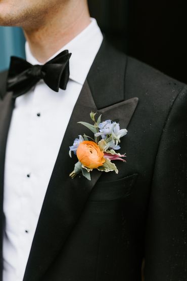 Colorful spring boutonniere on groom's lapel at City Winery Hudson Valley wedding