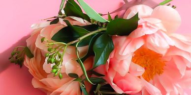 Peonies and french ladurée macaroons over table