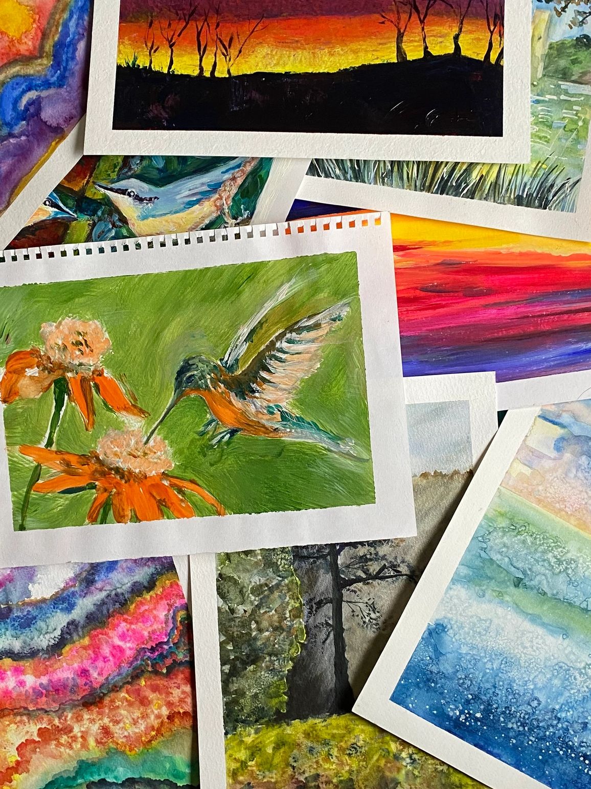 Collection of colorful paintings depicting nature and landscapes.