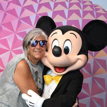 Mary Karlo hugging Mickey Mouse