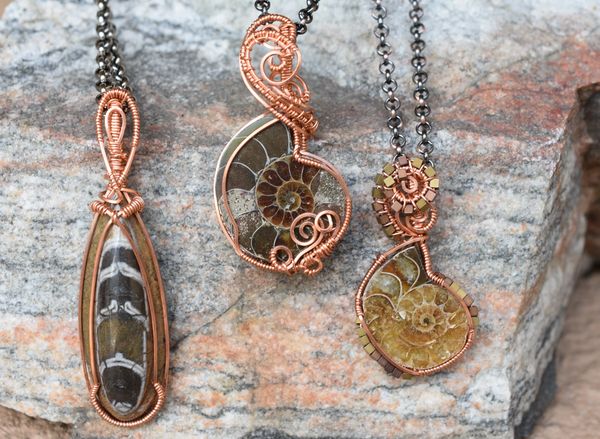 Wire wrapped artisan fossil pendants with chains.