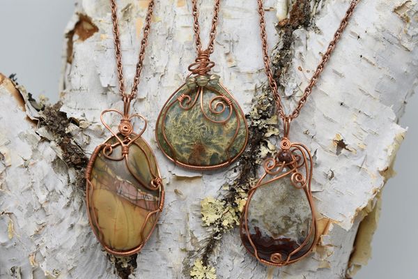 Large to medium wrapped stone pendants with necklace chains.