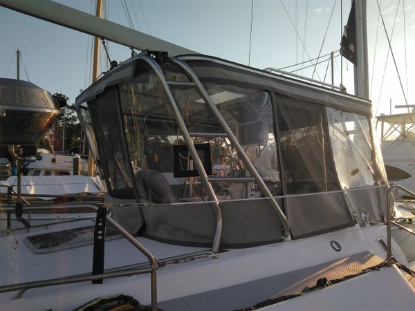 Custom Hunter sailboat enclosure with screened zip out enclosure panels