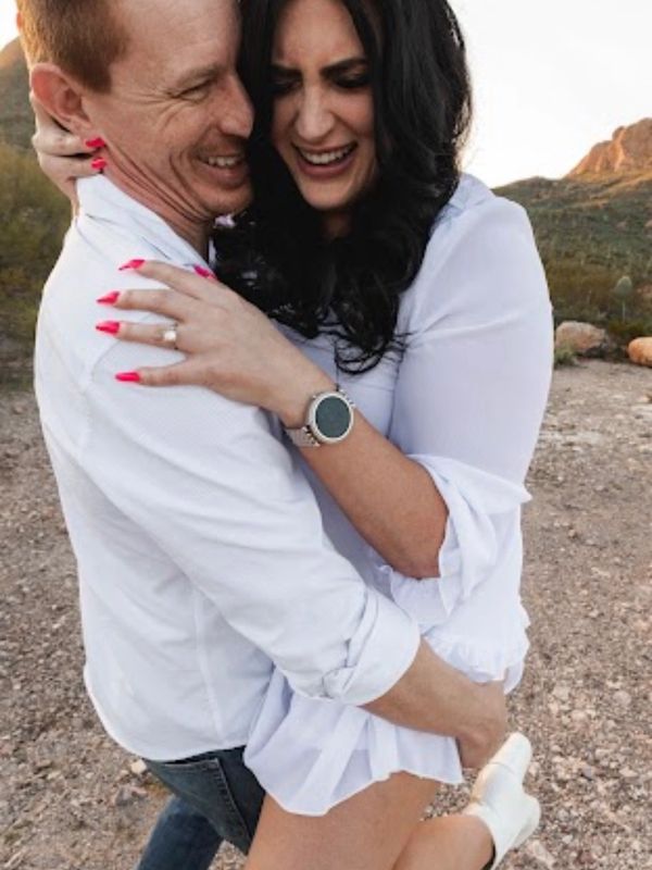 man holding woman, laughing, 