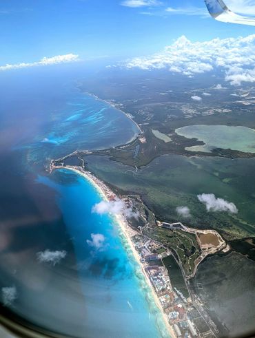 Aerial view of a coastal city with turquoise waters and beaches.