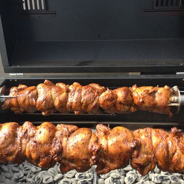 Whole Chickens on a charcoal grill. 