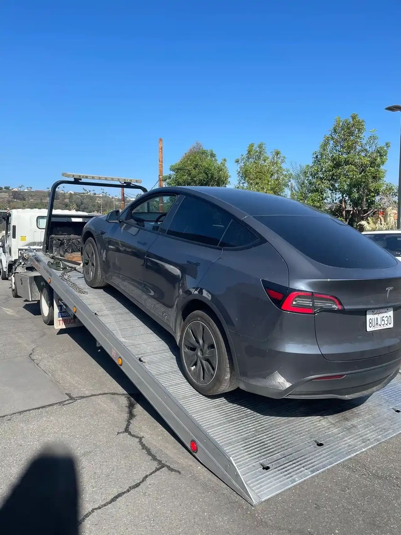 TESLA BEING TOWED IN FLATBED IN ORANGE COUNTY 