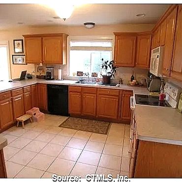 Custom Kitchen cabinets with a porcelain tile floor 