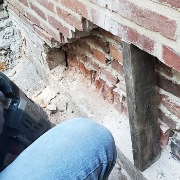 Upper brick courses are shored