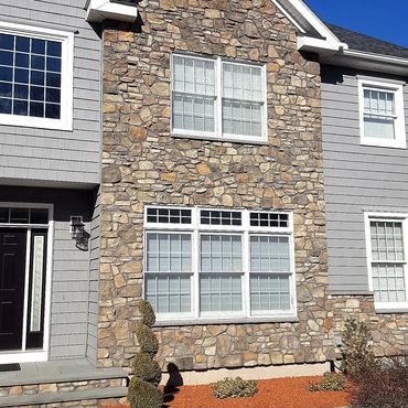 Cultured stone is pointed with a black mortar to accentuate the stone  
