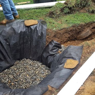 This new dry-well is dug approx 100' from the house and a trench for the 4" pipe is installed to thi