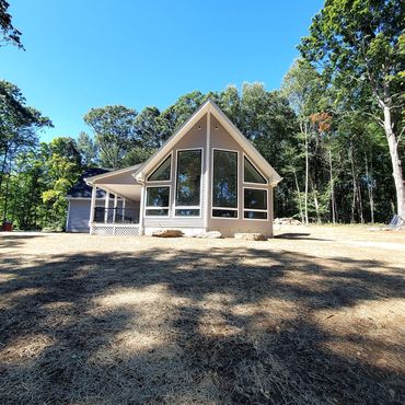 Large Andersen Windows overlooking a beautiful vineyard. This home has a large front porch with comp