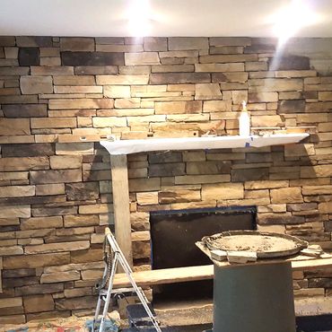 Cultured stone dry stack veneer around a fireplace