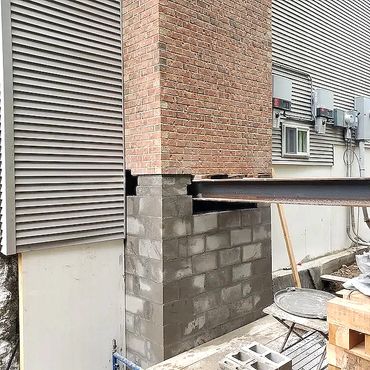 New reinforced masonry block foundation is installed and the steel beams are ready to come out