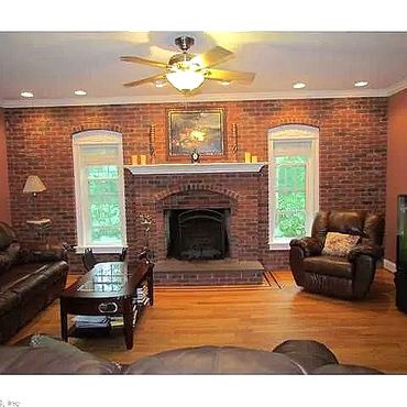 Living Room - A full wall masonry brick veneer fireplace with a raised brownstone heart and a custom