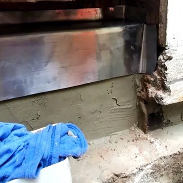 The inner brick leaf is plastered and a lead flashing pan is installed