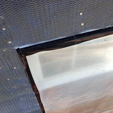 Flashing wrapped around window flange and wire lath on top to accept the plaster