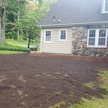 The new Dry-well system is backfilled and top soil is spread. The new lawn is installed for completi