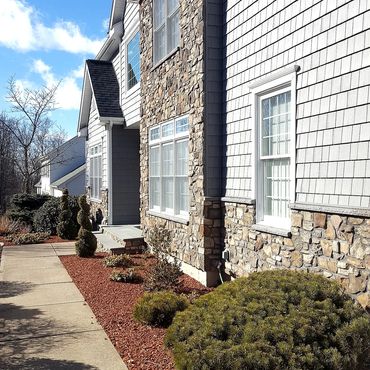 The new house exterior remodel is complete with Cultured stone and Cedar Impression shingles