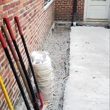 Inside edge of concrete base is removed and brick wall removal is about to begin
