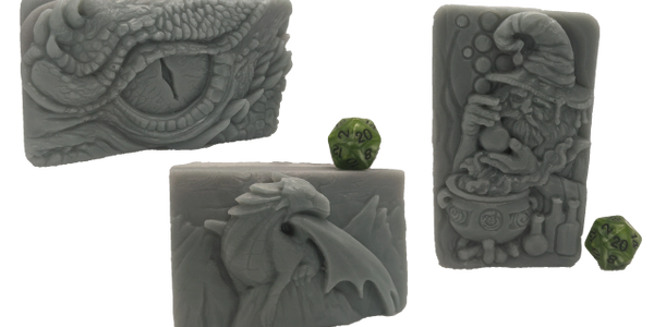 Molded soaps. A Dragon Eye with scales, a Dragon Sitting on a peak of a mountain, and a wizard/alche