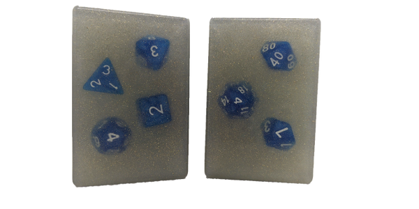 Two rectangular bars of soap with a polyhedral set of dice suspended inside. 