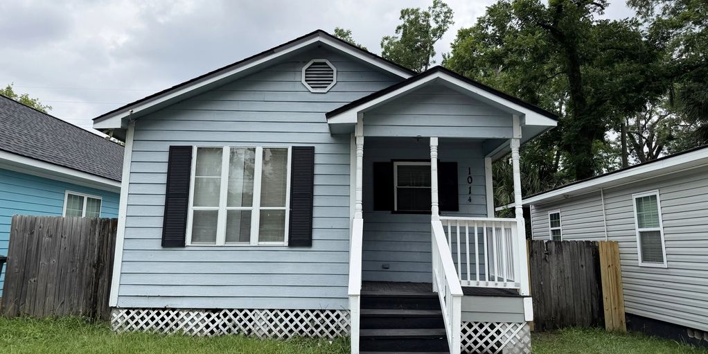 Small blue house with white trim and a front porch.