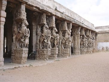 Ancient stone pillars with detailed carvings.