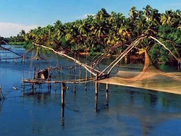 Traditional fishing nets over a river with lush greenery.