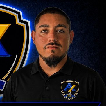 Man in black polo with soccer club logo.