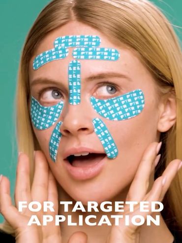 Woman with blue skincare patches on her face for targeted application.