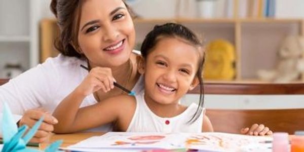 Teacher helping a student with coloring