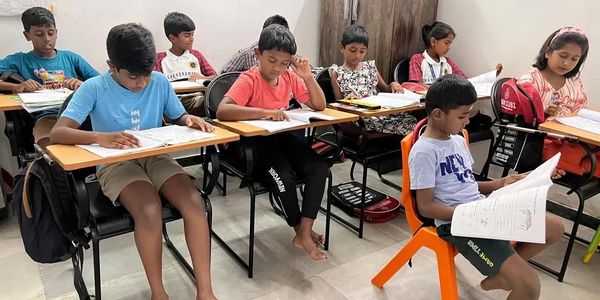 Children attentively studying in a classroom setting.